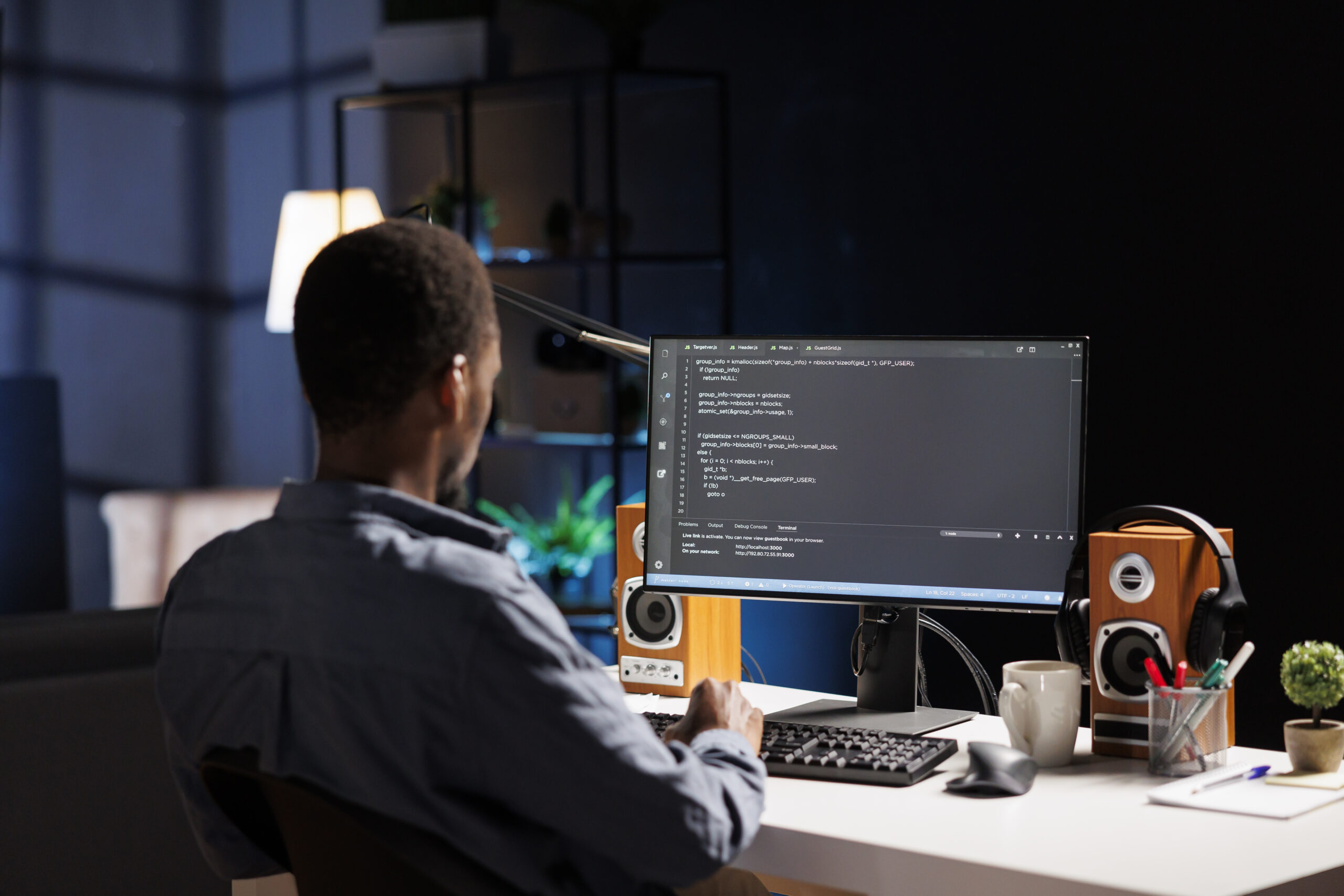 Male developer entering binary data on terminal panel while establishing html code. Software engineer works on troubleshooting with programming language, for protection of databases.